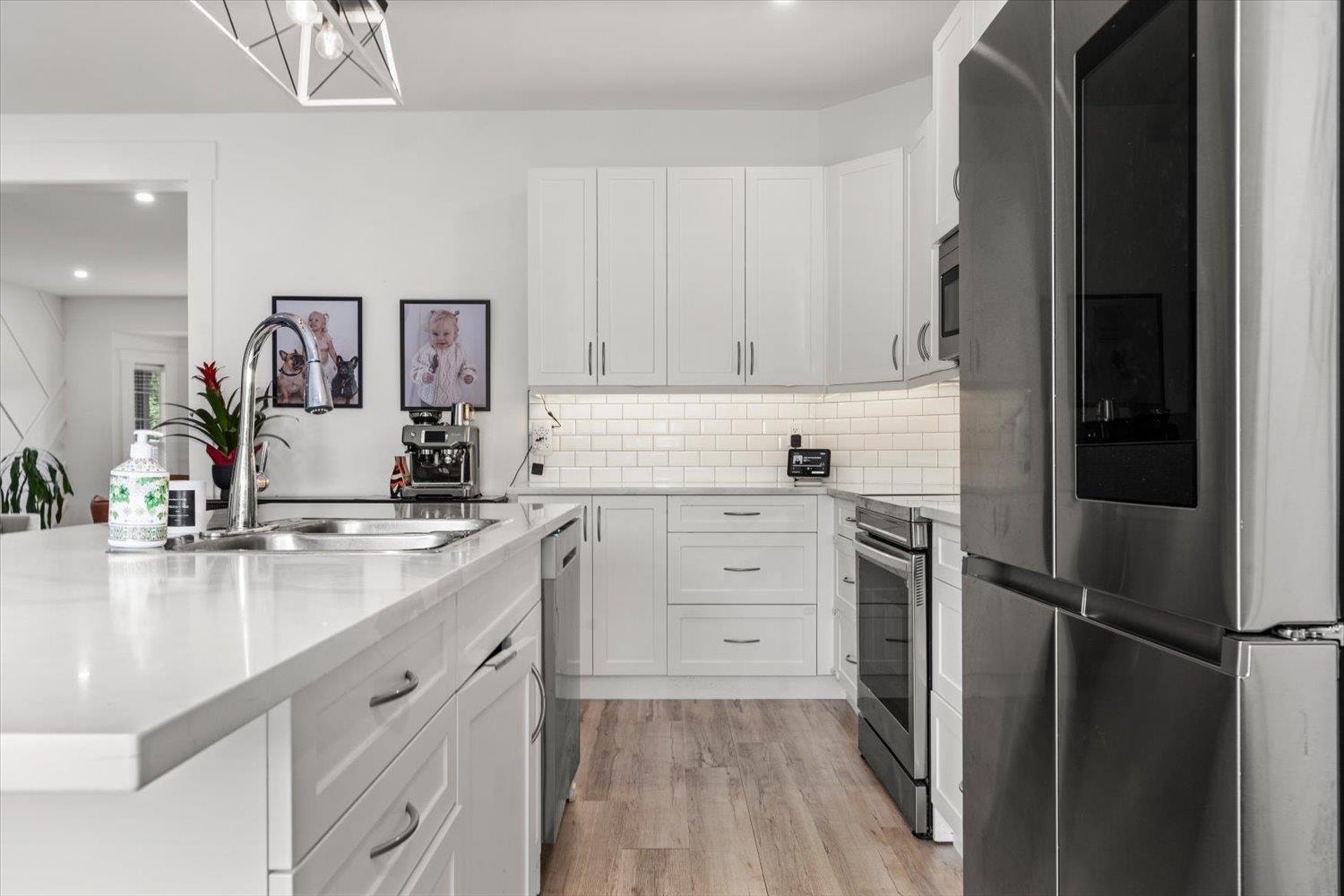 Bright white kitchen with stainless steel appliances at 46409 Bedford Parkway, Sardis