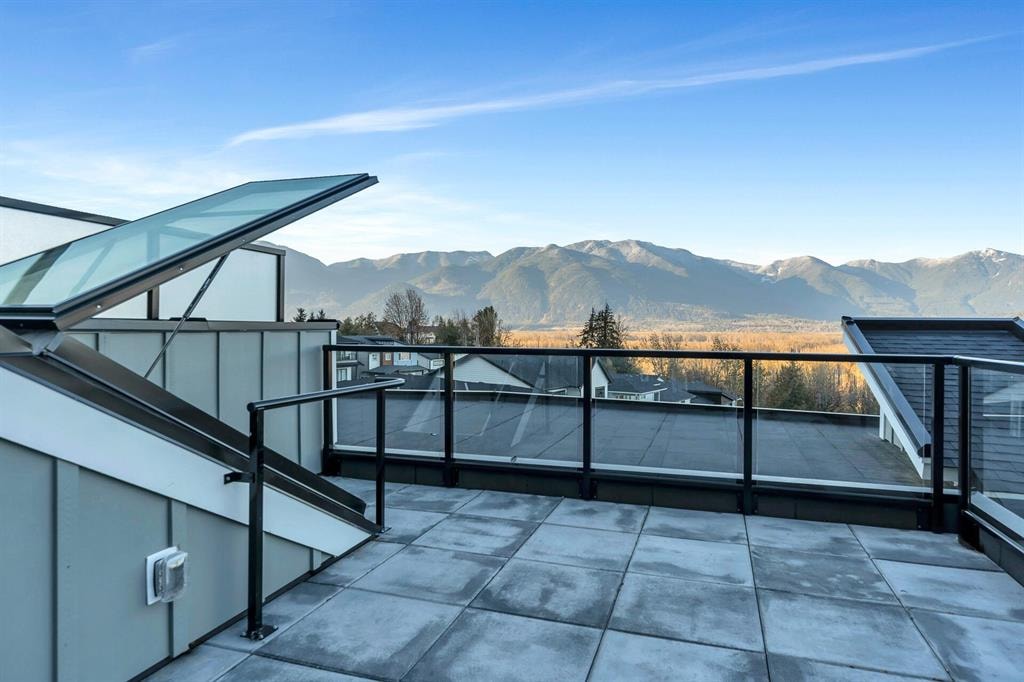 Rooftop patio with glass railings at 26 43998 Chilliwack Mountain Road, overlooking mountain and valley views